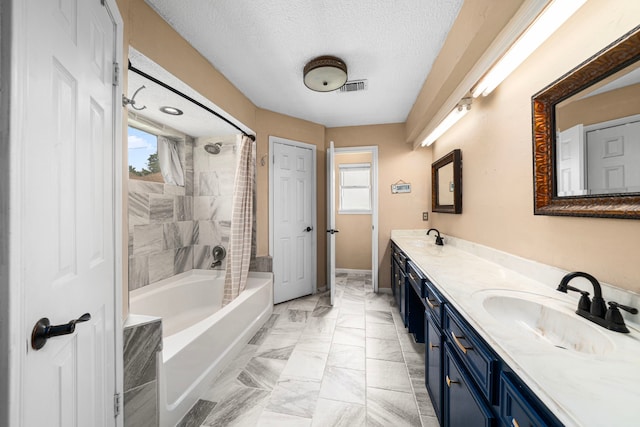 8023 Litchfield Ln, Spring, TX 77379 - full bathroom featuring double vanity, marble finish floors, shower / bath combo with shower curtain, a textured ceiling, and baseboards