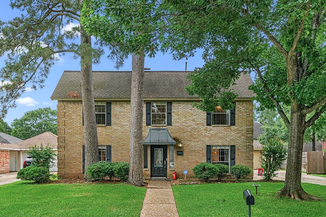 8023 Litchfield Ln, Spring, TX 77379 - view of front of property featuring a front yard, a shingled roof, and brick siding