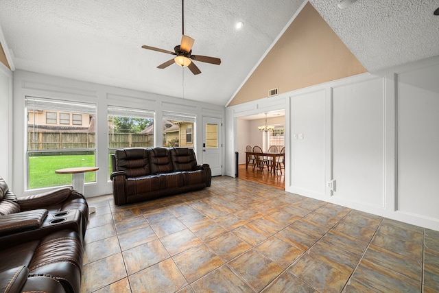 8023 Litchfield Ln, Spring, TX 77379 - living room featuring a decorative wall, a textured ceiling, a ceiling fan, vaulted ceiling, and a chandelier