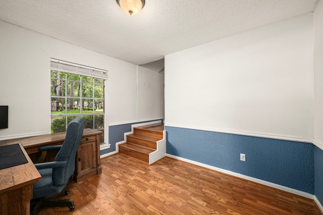 8023 Litchfield Ln, Spring, TX 77379 - office with wood finished floors, a textured ceiling, and baseboards