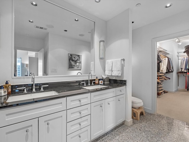 2520 Robinhood St Unit 1012, Houston, TX 77005 - full bath with double vanity, recessed lighting, toilet, baseboards, and a walk in closet