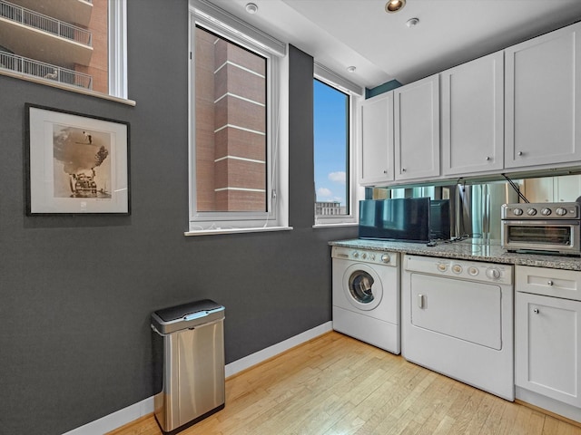 2520 Robinhood St Unit 1012, Houston, TX 77005 - washroom with light wood finished floors, baseboards, and independent washer and dryer