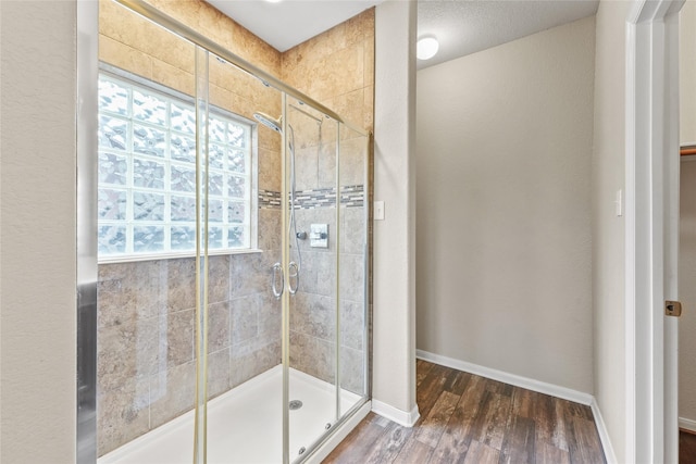 7427 Pony Crk, Missouri City, TX 77459 - bathroom with a stall shower, wood finished floors, and baseboards