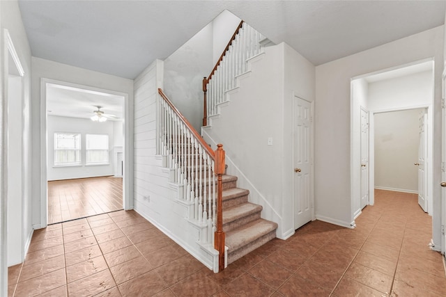 7427 Pony Crk, Missouri City, TX 77459 - stairway featuring a ceiling fan, baseboards, and tile patterned floors