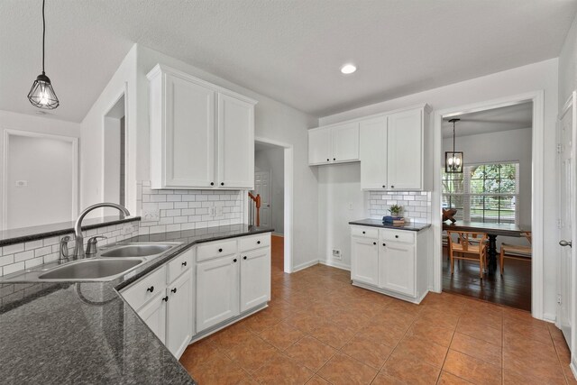 7427 Pony Crk, Missouri City, TX 77459 - kitchen with a sink, tasteful backsplash, white cabinetry, pendant lighting, and recessed lighting