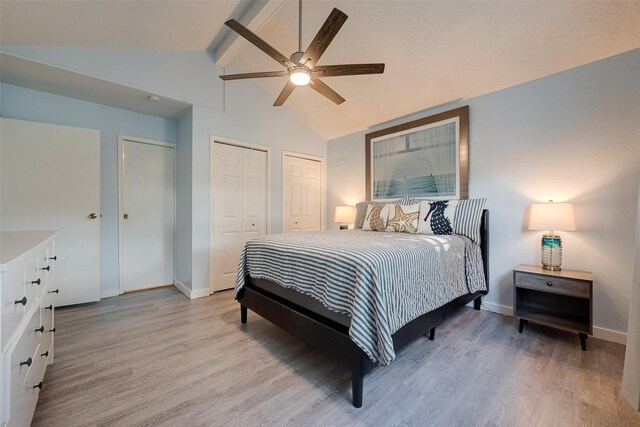 1717 22nd St, Galveston, TX 77550 - bedroom with two closets, beamed ceiling, light wood-style floors, baseboards, and high vaulted ceiling