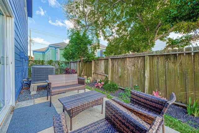 1717 22nd St, Galveston, TX 77550 - fenced backyard with central AC unit, a patio, and outdoor lounge area