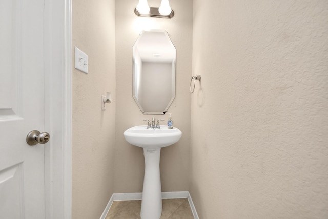 3922 Crestwind Ln, Richmond, TX 77407 - bathroom with tile patterned flooring, a sink, and baseboards