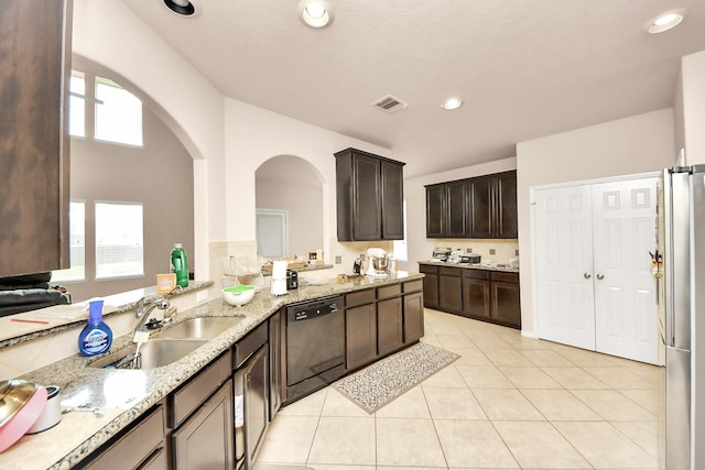 3922 Crestwind Ln, Richmond, TX 77407 - kitchen with dishwashing machine, a sink, freestanding refrigerator, dark brown cabinetry, and light stone counters