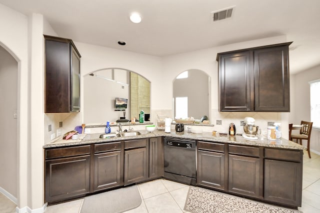 3922 Crestwind Ln, Richmond, TX 77407 - kitchen featuring black dishwasher, arched walkways, a sink, light stone countertops, and recessed lighting