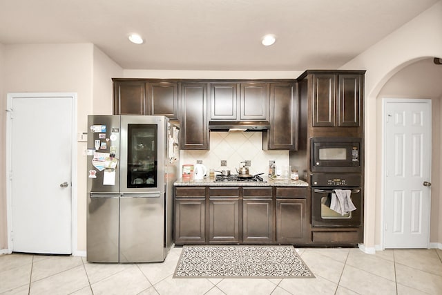 3922 Crestwind Ln, Richmond, TX 77407 - kitchen featuring black appliances, under cabinet range hood, dark brown cabinetry, tasteful backsplash, and recessed lighting