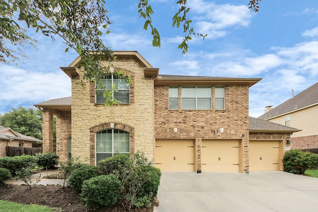 3922 Crestwind Ln, Richmond, TX 77407 - traditional-style house featuring stone siding, concrete driveway, brick siding, and a garage