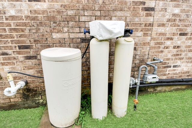 3922 Crestwind Ln, Richmond, TX 77407 - exterior view of brick siding and a water softener system