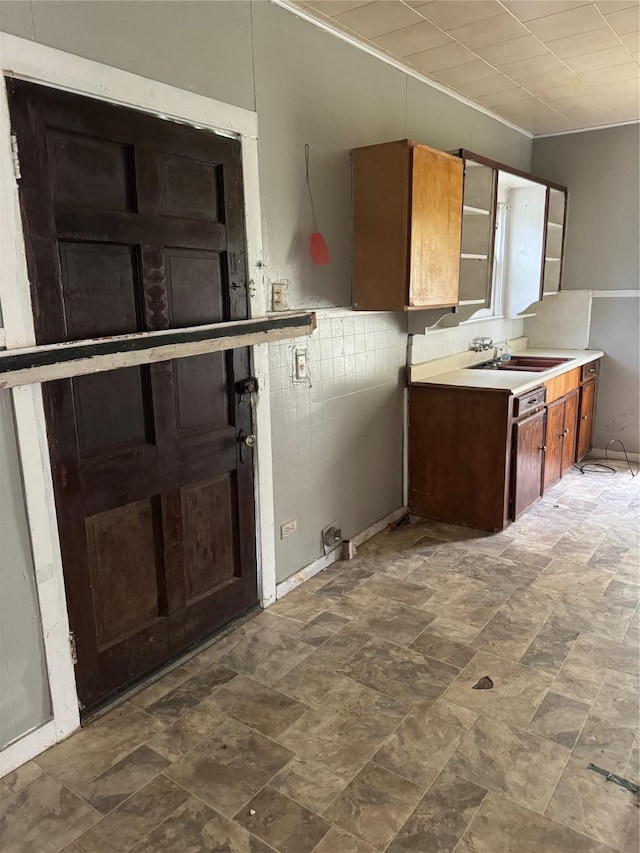 4204 Wipprecht St, Houston, TX 77026 - kitchen featuring a sink, light countertops, crown molding, and stone finish flooring