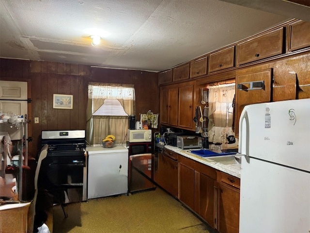 4204 Wipprecht St, Houston, TX 77026 - kitchen with white appliances, light countertops, light carpet, and wooden walls