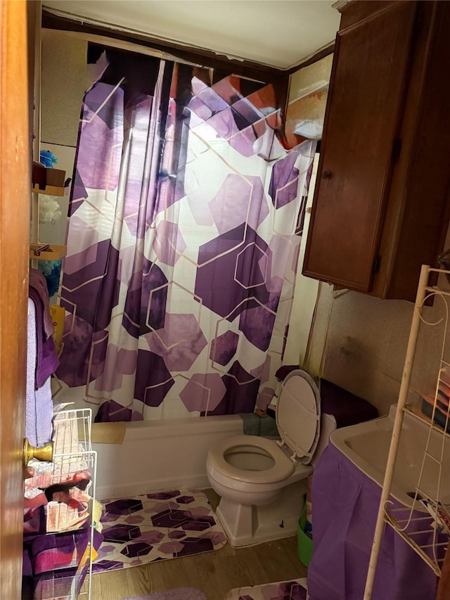 4204 Wipprecht St, Houston, TX 77026 - bathroom featuring shower / tub combo with curtain, toilet, and wood finished floors