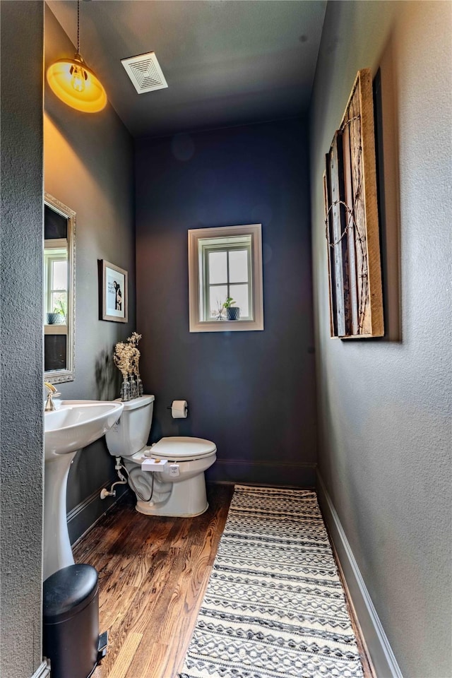 242 E 28th St, Houston, TX 77008 - half bath featuring toilet, wood finished floors, and baseboards