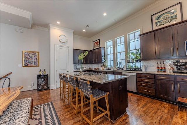 242 E 28th St, Houston, TX 77008 - kitchen featuring stainless steel dishwasher, a breakfast bar, crown molding, dark brown cabinetry, and light stone countertops