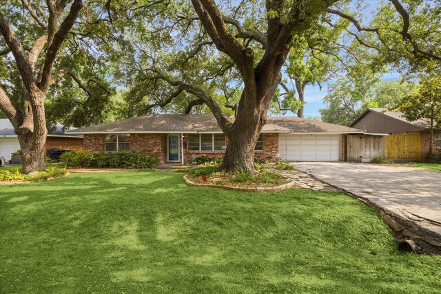 8721 Greiner Dr, Houston, TX 77080 - single story home featuring a garage, brick siding, concrete driveway, a front yard, and a shingled roof