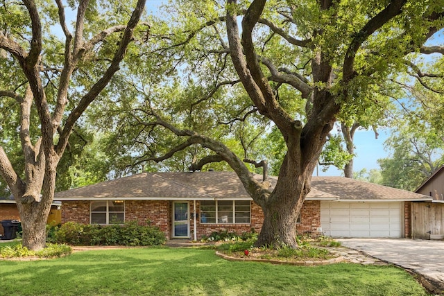 8721 Greiner Dr, Houston, TX 77080 - single story home featuring a garage, concrete driveway, a front yard, and brick siding