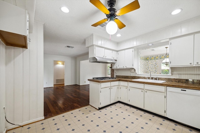 8721 Greiner Dr, Houston, TX 77080 - kitchen with white dishwasher, a sink, dark countertops, stainless steel gas cooktop, and a textured ceiling