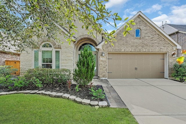 16819 Talisker Dr, Richmond, TX 77407 - french country home featuring an attached garage, driveway, a front yard, and stone siding