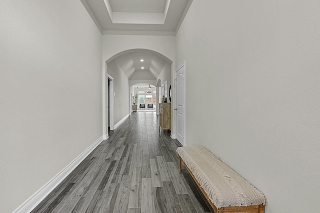 16819 Talisker Dr, Richmond, TX 77407 - hallway with arched walkways, dark wood-style flooring, and baseboards