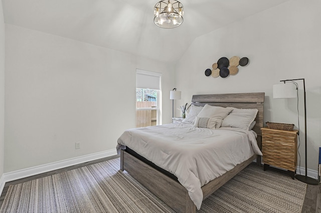 16819 Talisker Dr, Richmond, TX 77407 - bedroom featuring baseboards, vaulted ceiling, a chandelier, and wood finished floors