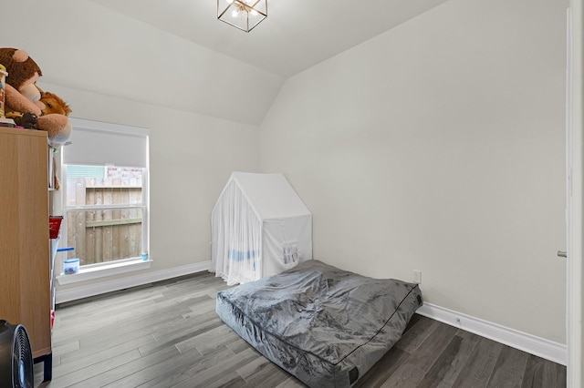 16819 Talisker Dr, Richmond, TX 77407 - bedroom with vaulted ceiling, wood finished floors, and baseboards