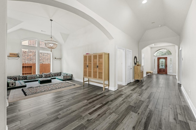 16819 Talisker Dr, Richmond, TX 77407 - foyer entrance with arched walkways, healthy amount of natural light, dark wood-style floors, high vaulted ceiling, and a chandelier