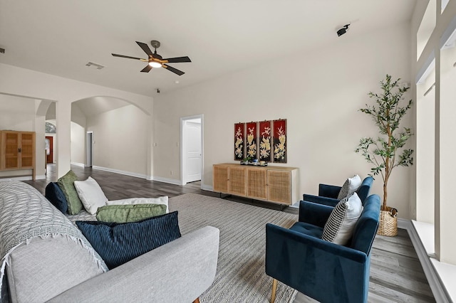 16819 Talisker Dr, Richmond, TX 77407 - living area with wood finished floors, arched walkways, ceiling fan, and baseboards