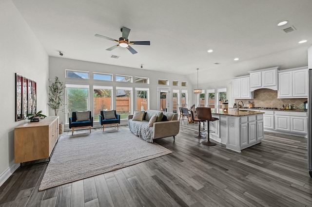 16819 Talisker Dr, Richmond, TX 77407 - living area featuring healthy amount of natural light, dark wood-style floors, a ceiling fan, recessed lighting, and baseboards