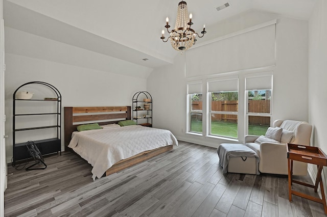 16819 Talisker Dr, Richmond, TX 77407 - bedroom featuring vaulted ceiling, a chandelier, and wood finished floors