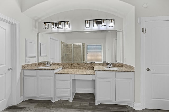 16819 Talisker Dr, Richmond, TX 77407 - bathroom with a shower stall, double vanity, and wood finished floors