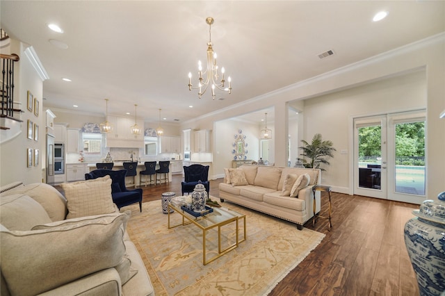 2314 Red Fox Dr, Missouri City, TX 77459 - living area with wood finished floors, a chandelier, plenty of natural light, crown molding, and recessed lighting