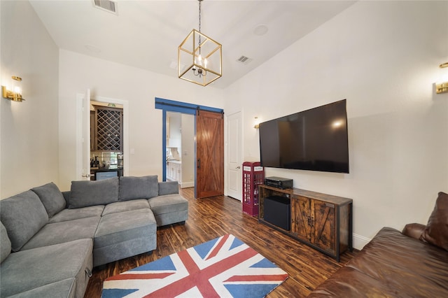 2314 Red Fox Dr, Missouri City, TX 77459 - living area featuring wood finished floors, a barn door, a dry bar, a chandelier, and baseboards