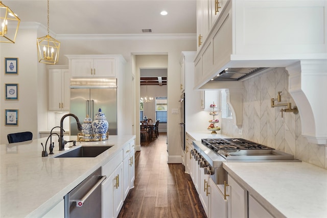 2314 Red Fox Dr, Missouri City, TX 77459 - kitchen with a sink, a chandelier, appliances with stainless steel finishes, dark wood finished floors, and white cabinets