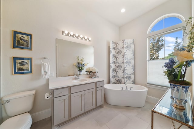 2314 Red Fox Dr, Missouri City, TX 77459 - full bathroom with vanity, healthy amount of natural light, baseboards, and a freestanding tub