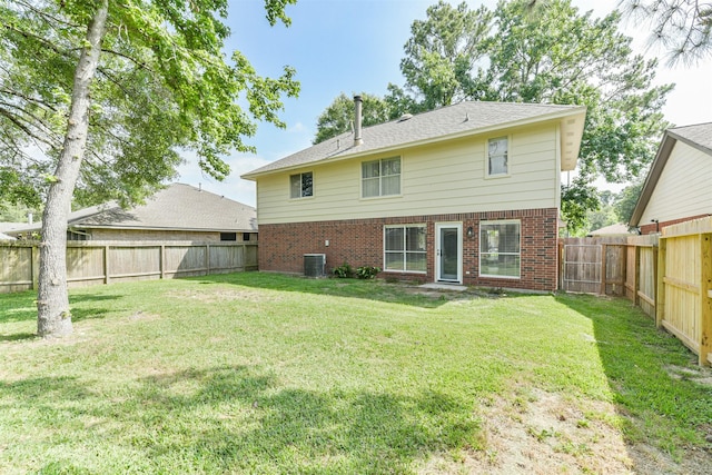 2318 Old Oak Ln, Kingwood, TX 77339 - back of property featuring brick siding and central air condition unit