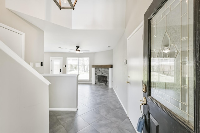 2318 Old Oak Ln, Kingwood, TX 77339 - tiled foyer entrance with a tiled fireplace, baseboards, and a ceiling fan