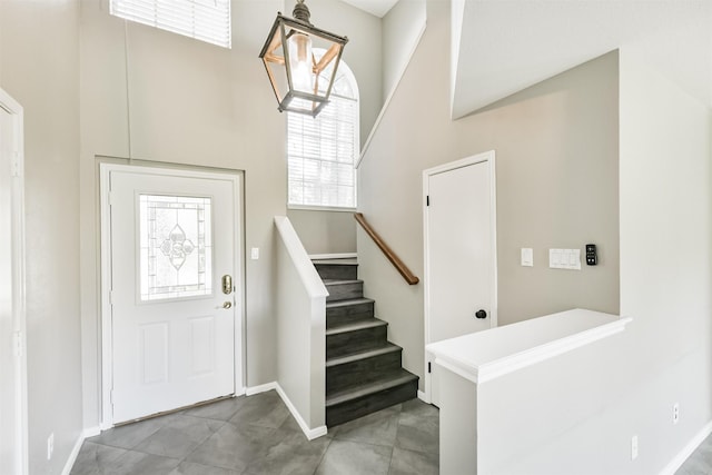 2318 Old Oak Ln, Kingwood, TX 77339 - entrance foyer with stairs, a towering ceiling, and baseboards