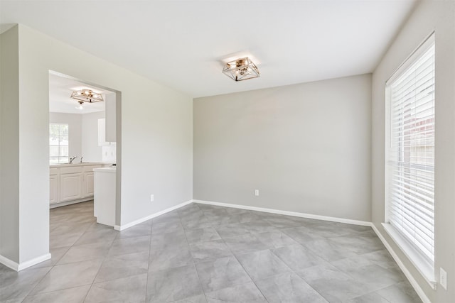 2318 Old Oak Ln, Kingwood, TX 77339 - empty room featuring baseboards and light tile patterned floors