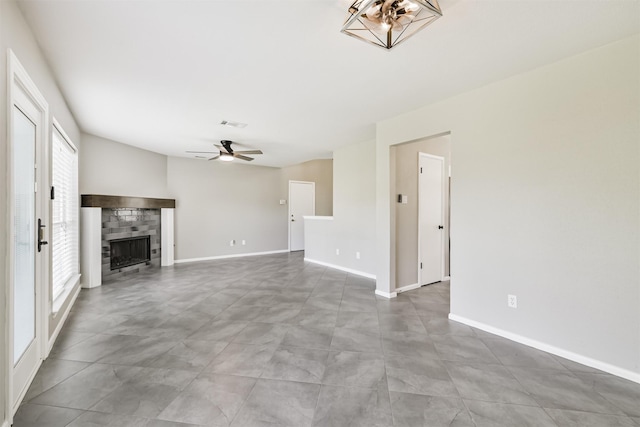 2318 Old Oak Ln, Kingwood, TX 77339 - unfurnished living room with healthy amount of natural light, ceiling fan, a tiled fireplace, and baseboards