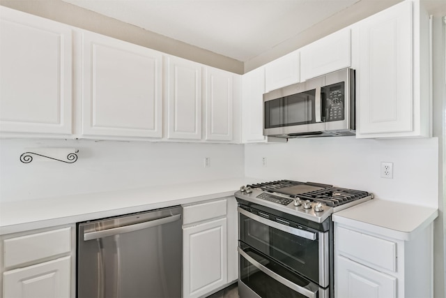 2318 Old Oak Ln, Kingwood, TX 77339 - kitchen with stainless steel appliances, white cabinets, and light countertops