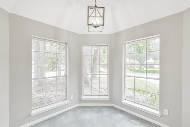 2318 Old Oak Ln, Kingwood, TX 77339 - unfurnished dining area featuring baseboards, plenty of natural light, marble finish flooring, and a chandelier