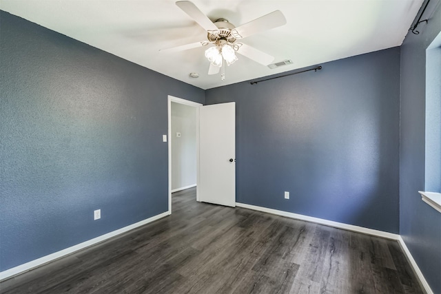 2318 Old Oak Ln, Kingwood, TX 77339 - unfurnished room featuring dark wood-type flooring, baseboards, and ceiling fan