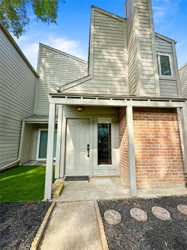 11731 Lakeside Place Dr, Houston, TX 77077 - property entrance featuring brick siding and a chimney