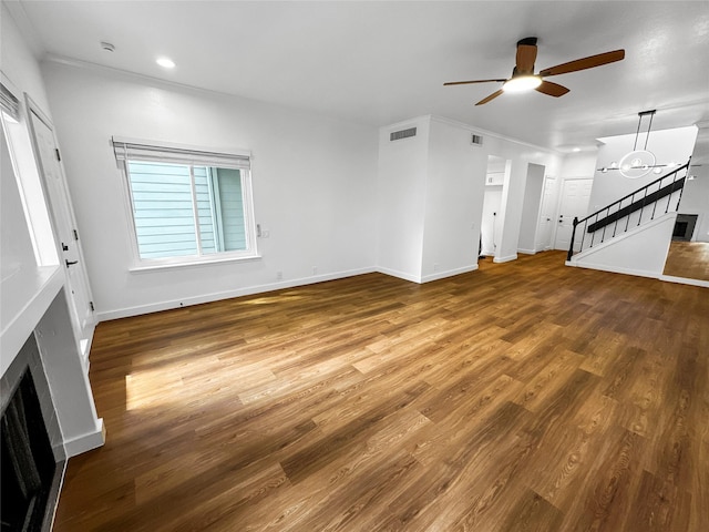 11731 Lakeside Place Dr, Houston, TX 77077 - unfurnished living room with ceiling fan, wood finished floors, crown molding, stairway, and a fireplace