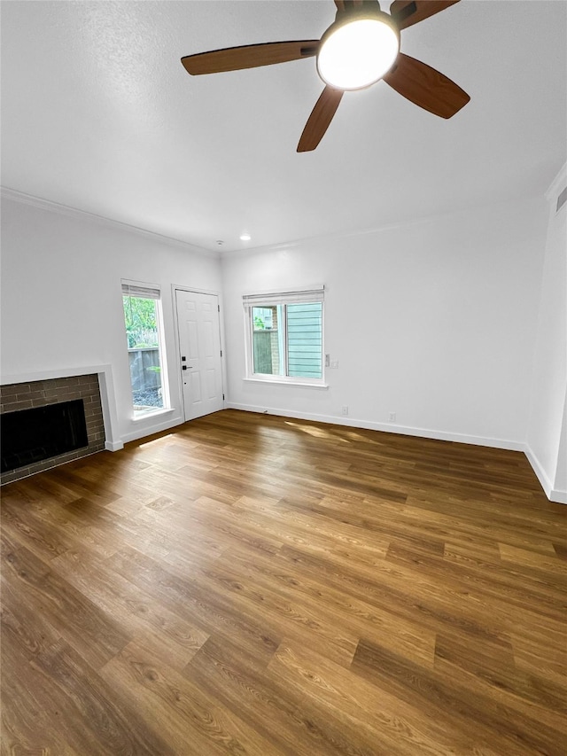 11731 Lakeside Place Dr, Houston, TX 77077 - unfurnished living room featuring a fireplace, wood finished floors, a ceiling fan, baseboards, and crown molding