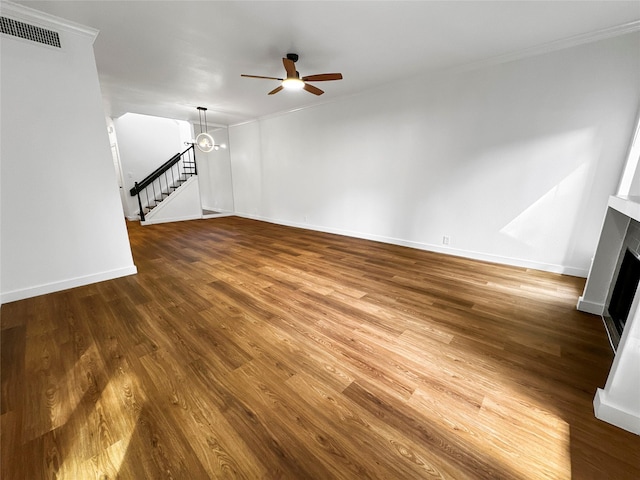 11731 Lakeside Place Dr, Houston, TX 77077 - unfurnished living room featuring ceiling fan, a fireplace, wood finished floors, ornamental molding, and baseboards